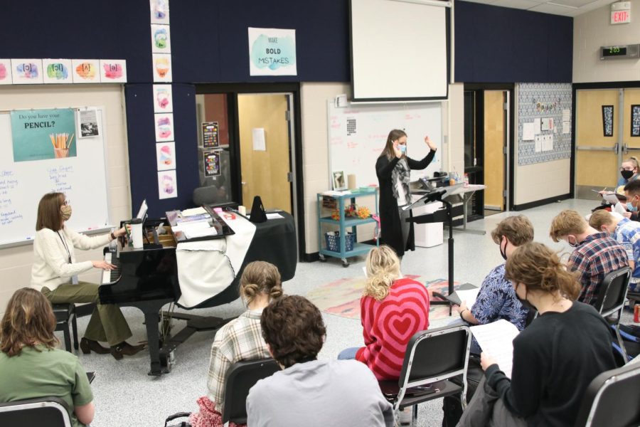 With both of her hands up, choir teacher Jessie. Reimer directs her choir class on Wednesday, Jan. 28.