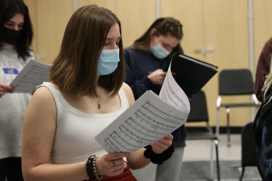 Looking at her music sheet, junior Asa Esparza sings along with the other students in her Jag Singers class.