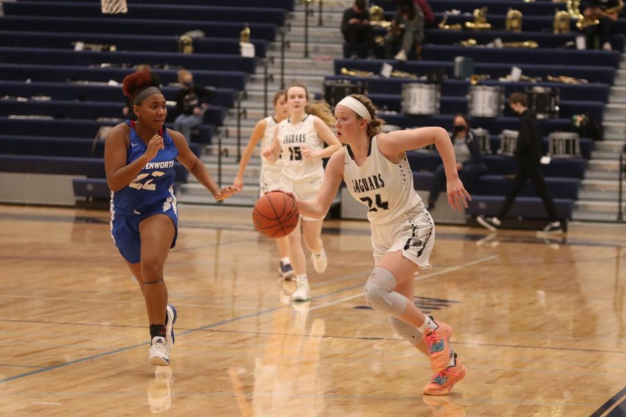 Going toward the basket, senior Emree Zars moves past the other teams player.