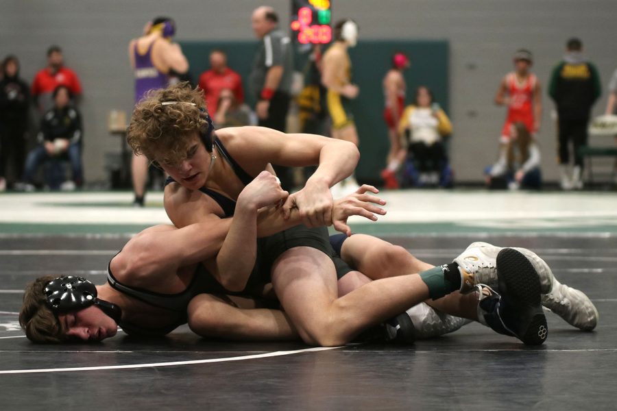 Lifting his opponent’s arm, sophomore Brady Mason works to score points.