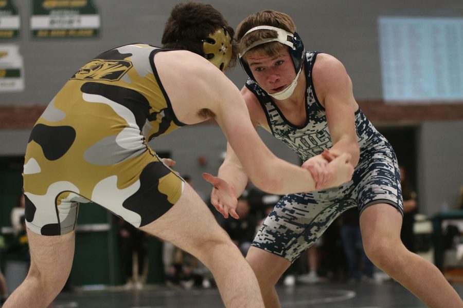 Reaching out, sophomore Hayden Applebee attempts to grab his opponent.