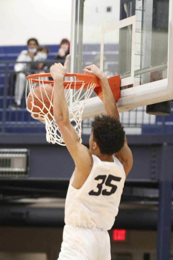 Senior Adrian Dimond manages to steal the ball and get a dunk on the opposing team. Adrian ended the game with 8 points on the board.