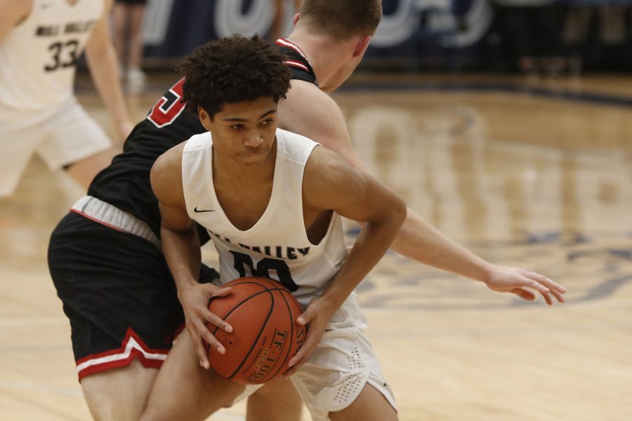 Junior Jameson Fisher blocks the ball form the opposing team so that one of his teammates can get open.