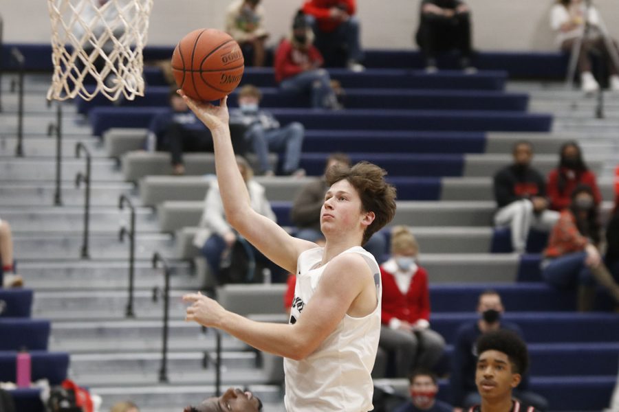 Junior Dylan Blazer jumps up to the basket for a layup. Dylan ended the game with 14 points.