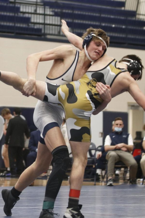 Raising his opponents leg, senior Jacob McGlasson prepares to slam him to the ground.