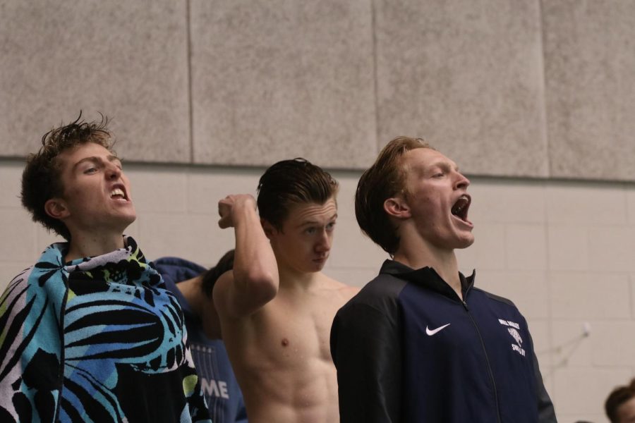 During a break for senior night celebrations, junior Anthony Molinaro and senior Derek Long cheer on the Blue Valley West seniors. 