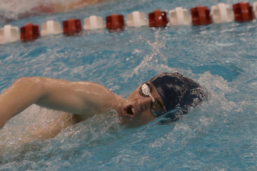 Arm extending out of the water, senior Derek Long sprints through the 50-yard freestyle Thursday, Jan. 27. Long finished with a time of 27.19. 