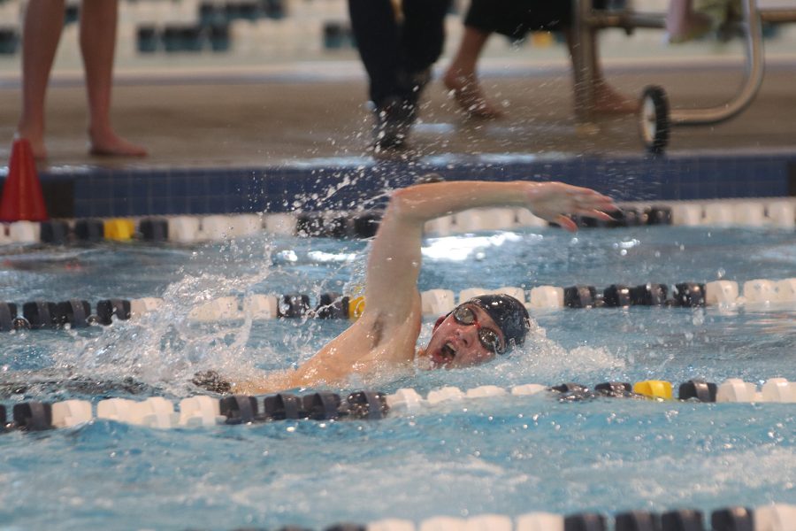 Arm in the air, sophomore Andre Arnold swims the men’s 200 freestyle Saturday, Jan. 22. Arnold earned a time of 2:05.77.
