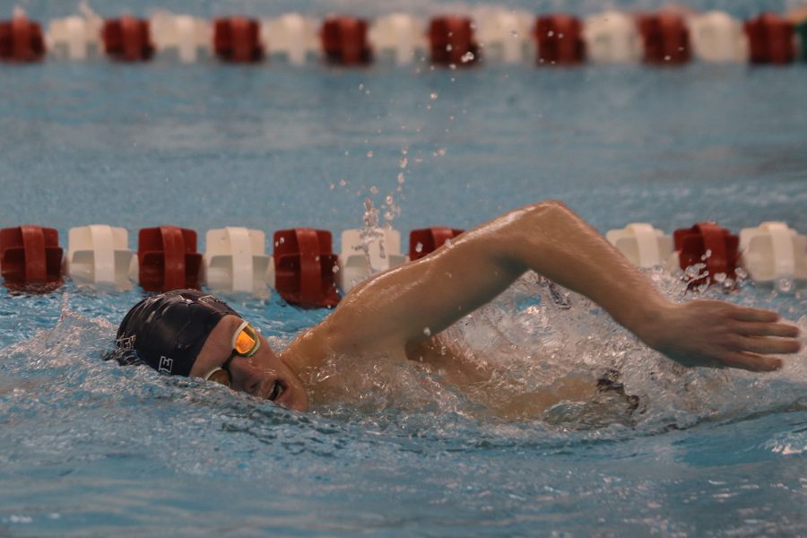 Taking a breath, junior Anthony Molinaro swims the 50-yard freestyle Thursday, Jan. 27 where he finished with a time of 22.92 seconds. 
