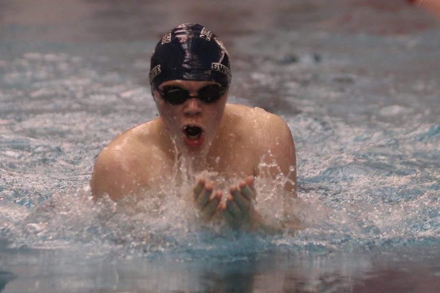 Hands up, sophomore Gabe Budimlija swims the 100-yard breaststroke Thursday, Jan. 27 where he finished with a time of 1:16.28. 
