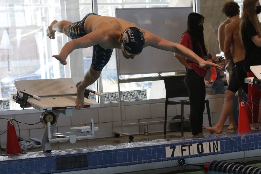 Before diving into the water, junior Anthony Molinaro prepares to compete in the men’s 50 m freestyle.
