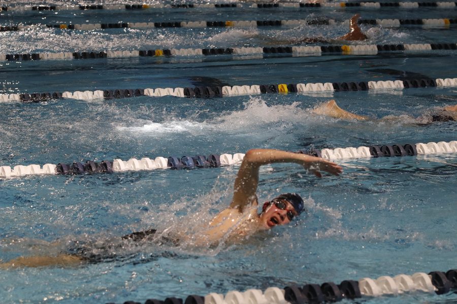 In the middle of a stroke, sophomore Andre Arnold races in the men’s 200 meter freestyle.