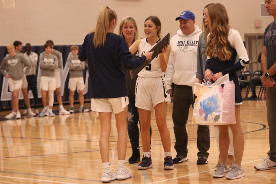 While accepting her gifts, senior Mackinley Fields smiles at junior Megan Kephart.