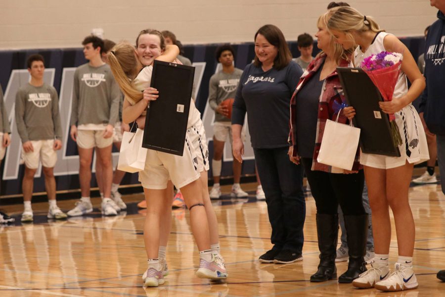 Smiling with gifts in hand, senior Greta Trowbridge hugs junior Sophie Pringle while her name is announced. 