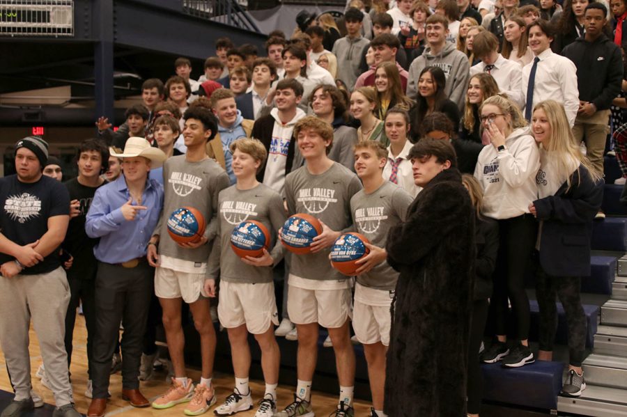 Posing with the crowd, seniors Adrian Dimond, Ben Fitterer, Zach Shrader and Jackson Van Dyke smile as their parents take pictures.