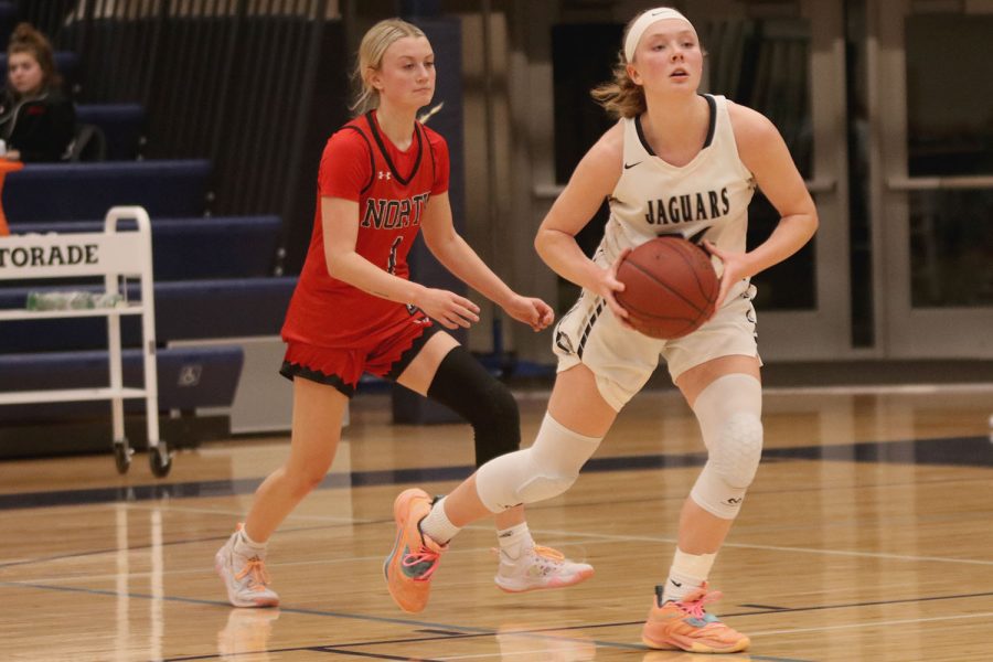 Lunching forward, senior Emree Zars looks to pass the ball. 