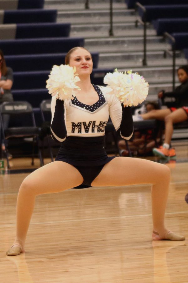 In the middle of the dance team’s performance, senior Ella Lorfing poses. 