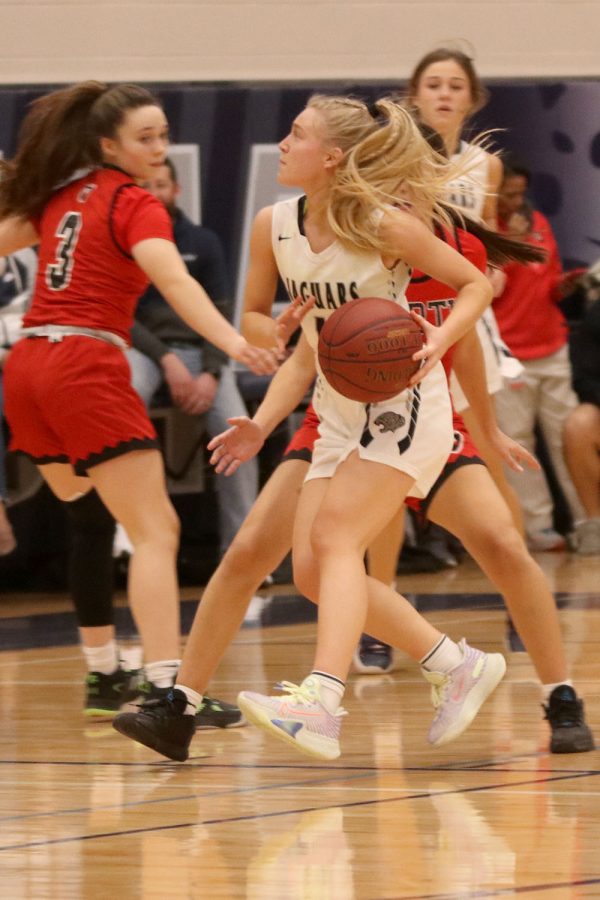 Surrounded by her opponents, junior Sophie Pringle gets ready to shoot the ball. 