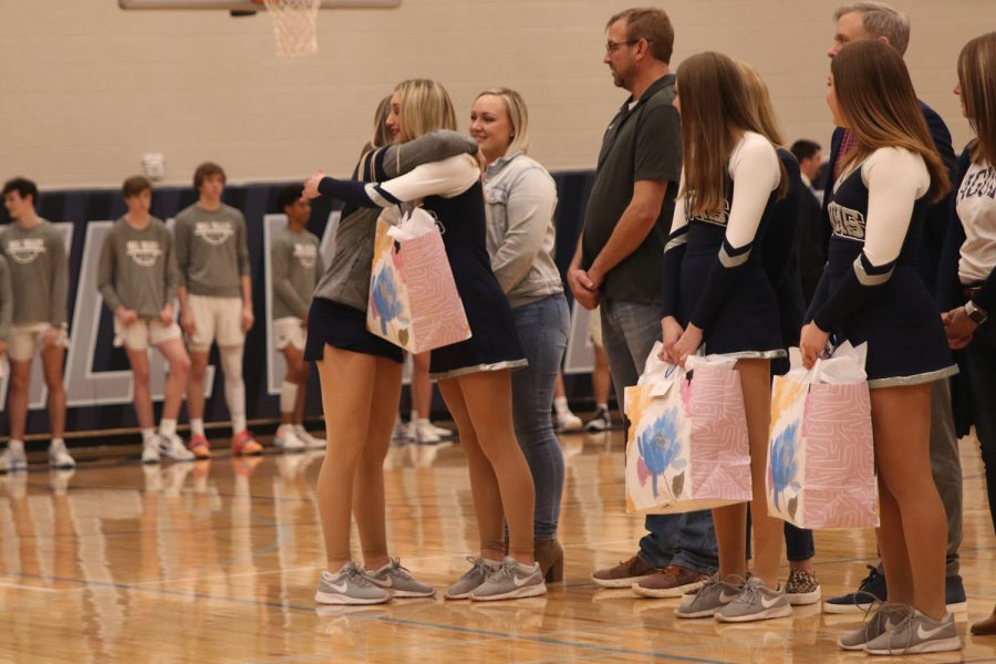 Besides her fellow silver stars, senior Hailey Mahoney receives her gift from the underclassmen on the team. 
