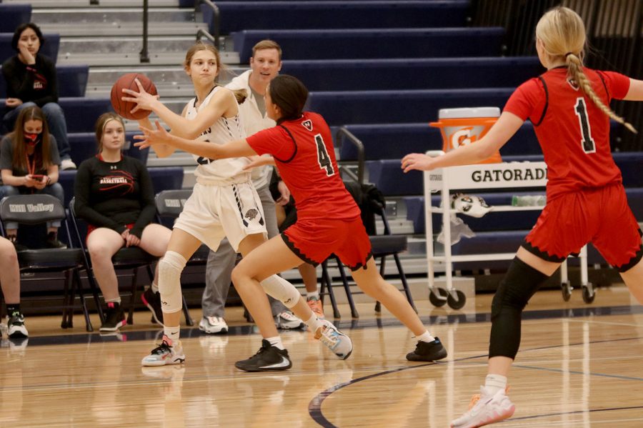 Looking for an opening to pass the ball, freshman Averie Landon attempts to avoid her opponent. 