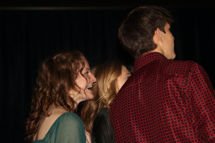 Smiling at her friends, senior Lauren Walker is enjoys the company of friends at the dance.