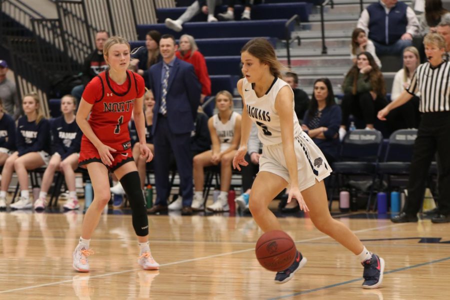 Ball in hand, senior Mackinley Fields runs down the court.