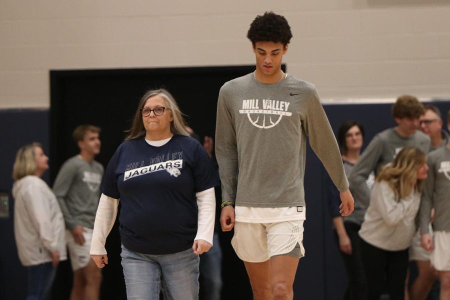 Senior Adrian Dimond walks across the court as his name is announced on senior night. 