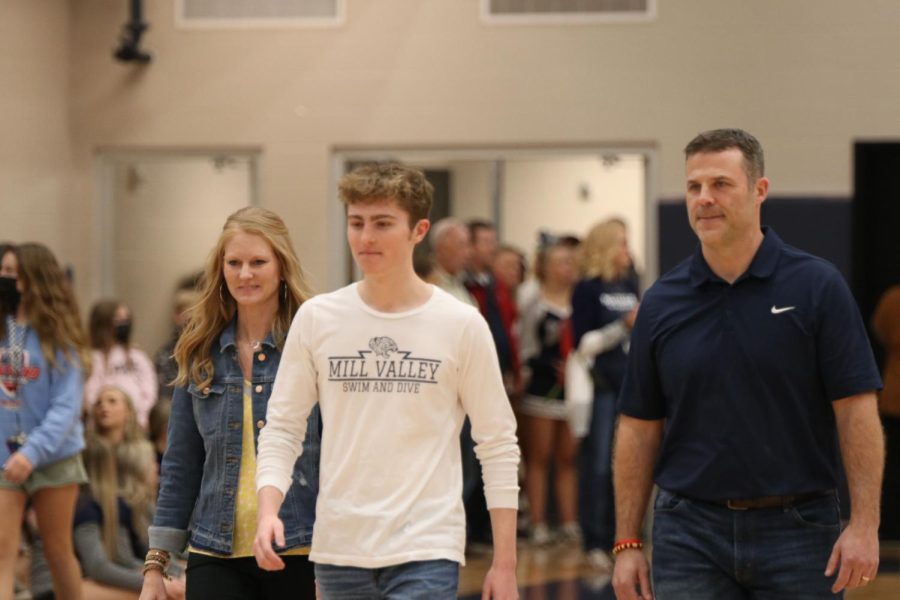 Senior Derek Long walks across the court as he is recognized as a boys swim and dive senior.