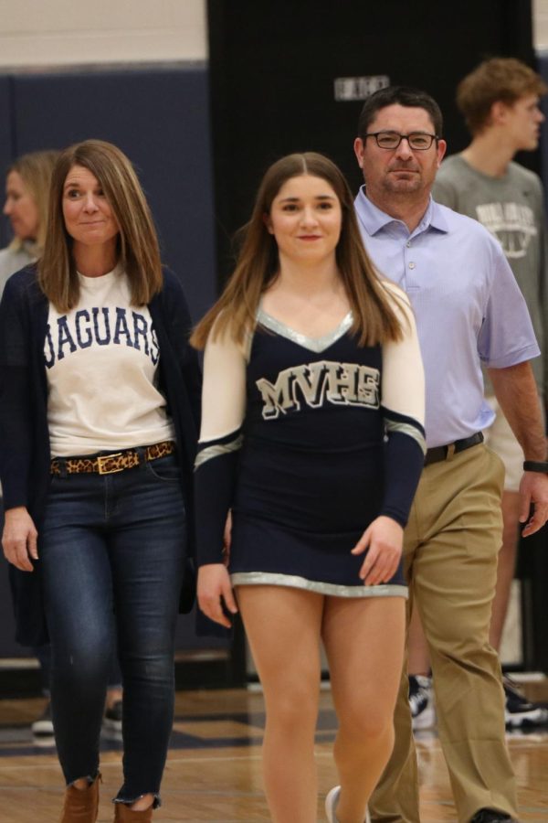 With a smile on her face, senior Anna Brazil walks across the court to be recognized as a dance senior.