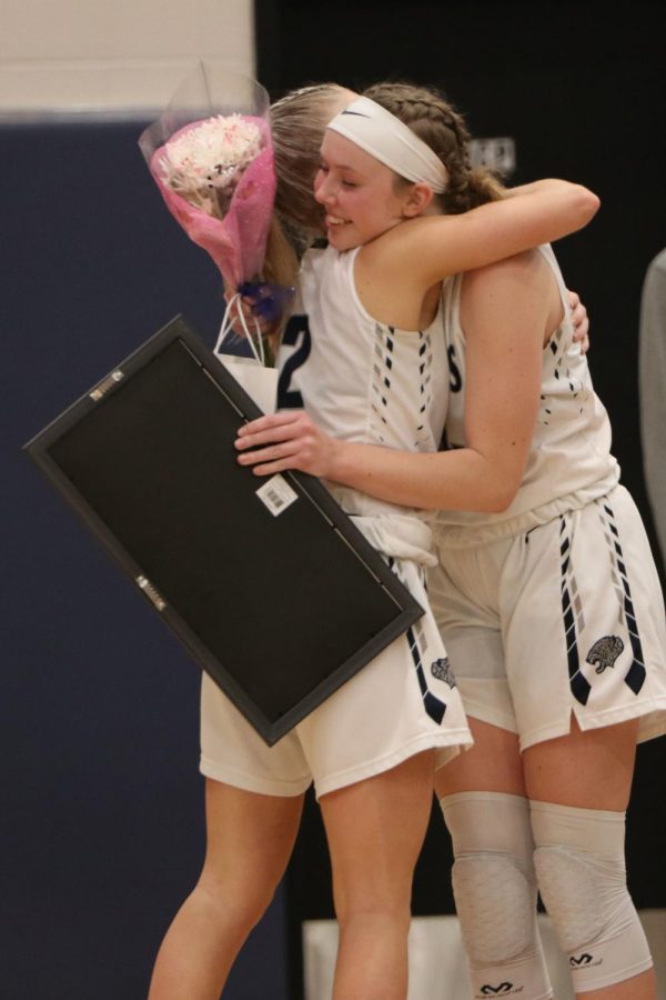 After giving senior Emree Zars her senior gift, sophomore Kiera Franken hugs her. 