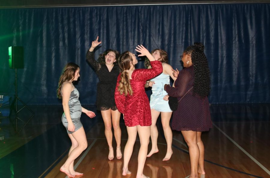 Clustered together, sophomores Kynley Verdict, Ellie Walker, Kate Pfeister, Lucy Roy and senior Hannah Hunter dance and jump in the air. 