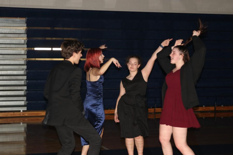 Clustered in a group, freshmen Hayden Wood, Riley Urban, Alaina Sweany and Lexus Pennel dance to a song.