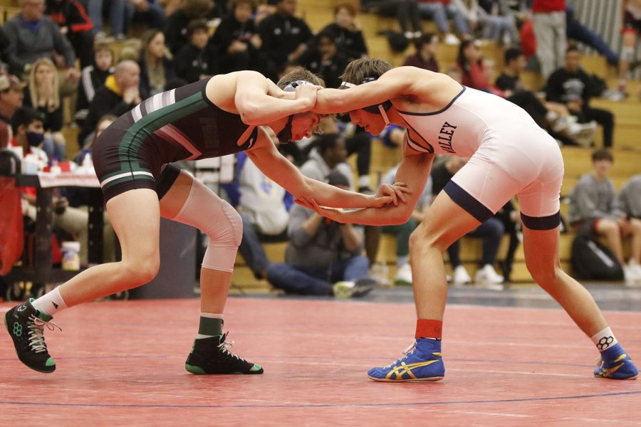 Starting his final match, junior Eddie Hughart interlocks arms with his opponent and begins to look for his next move. 