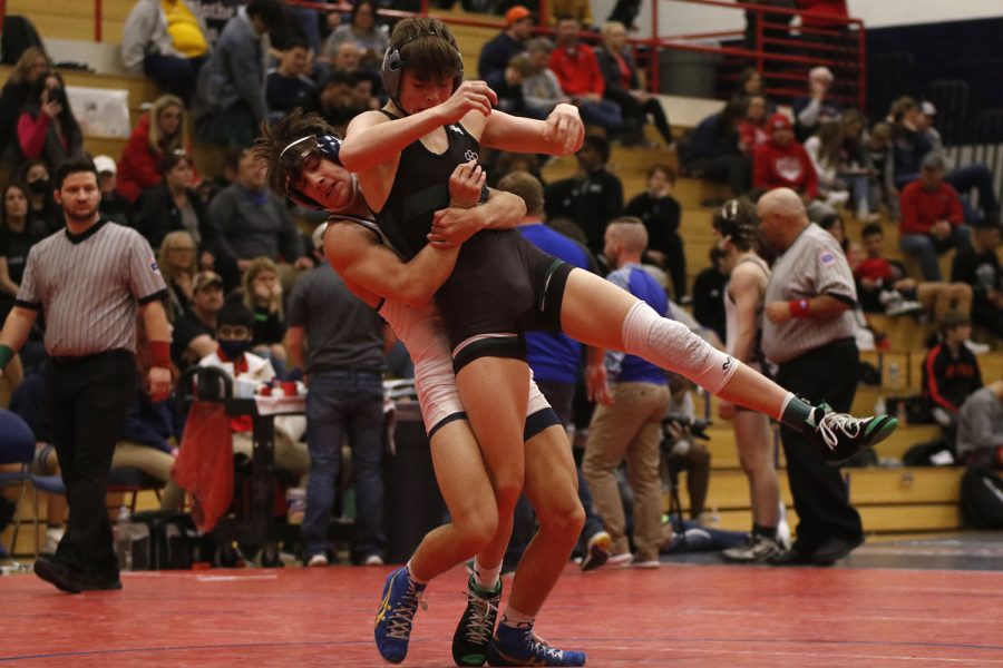 Ready to take his title as Sunflower League champion for his weight class, junior Eddie Hughart takes his opportunity to slam his opponent onto the mat.
