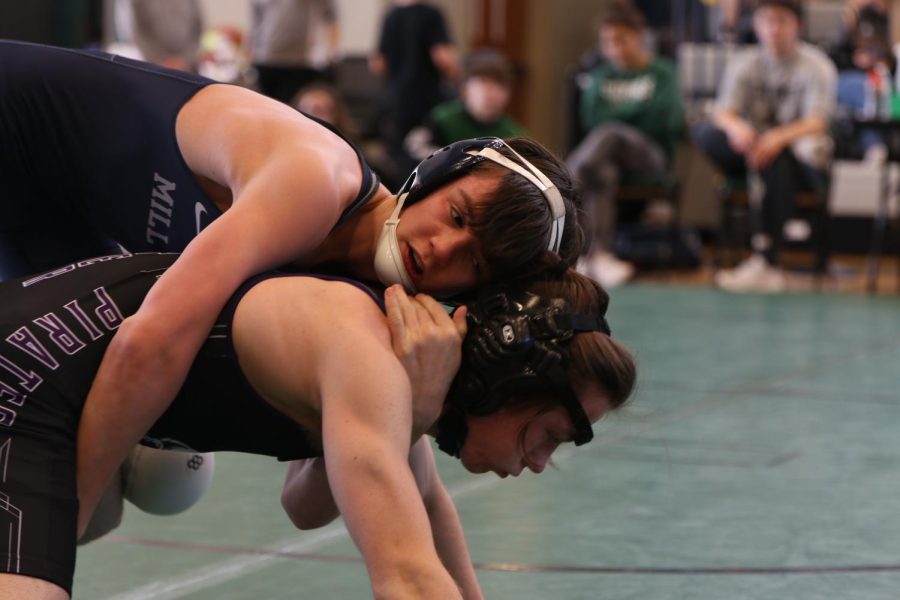 Sophomore Dillon Cooper grabs his opponent across their body to finish his takedown. 