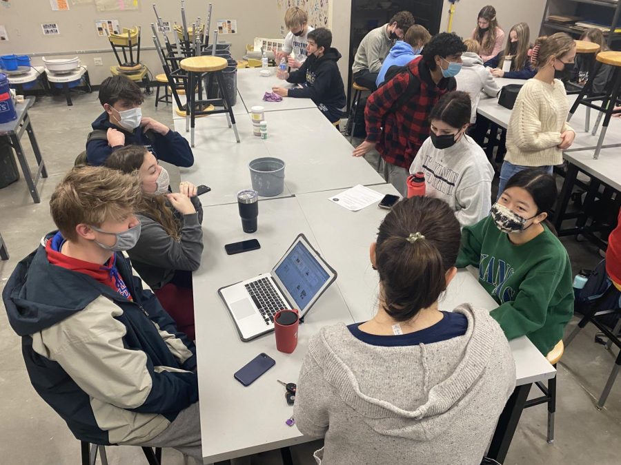 StuCo supervisor Erica Matyak helps other student council members  in discussing the details of the rescheduled Winter Homecoming dance