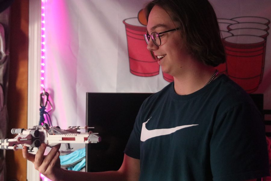 Lego plane in hand, senior Laird Toland shows off his room’s aesthetic.