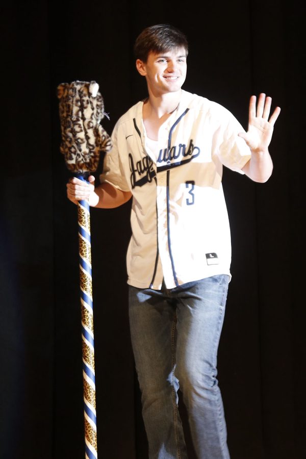 Holding the spirit stick, senior Nick Brubeck waves to the crowd while being introduced as Mr. Baseball.