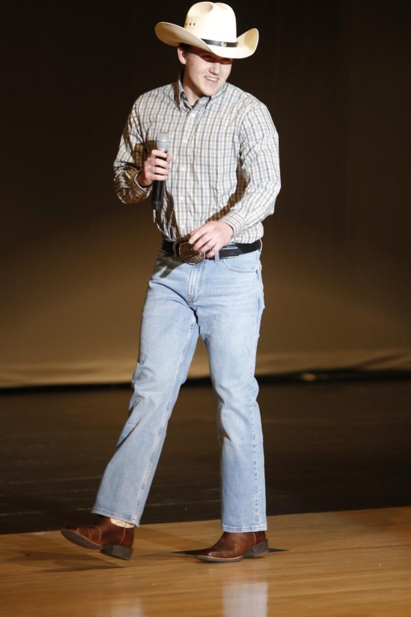 In jeans and a button-down shirt, senior Carson Miller sings "Chattahoochee" during the talent portion of the show.