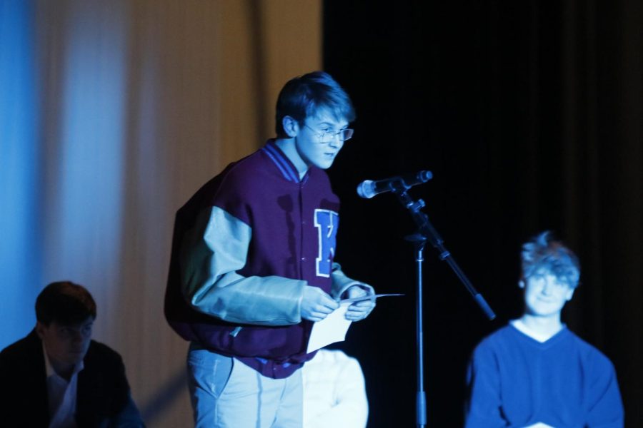 In glasses and a letterman's jacket, junior Brody Shulda recites the lyrics from "Stacy's Mom" by Fountain of Wayne.
