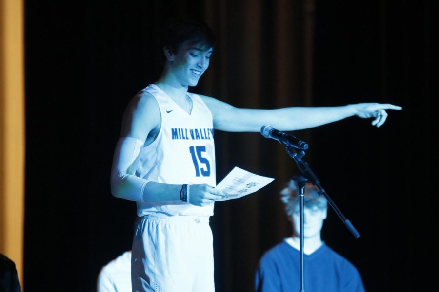 Pointing to the crowd, junior Marko Skavo reads his own original poem on how he will never be beat in basketball.