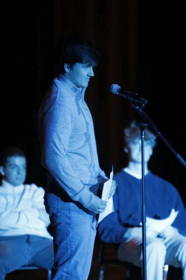 Senior Carson Miller, waits fo the audience attention so he can perform his poem.
