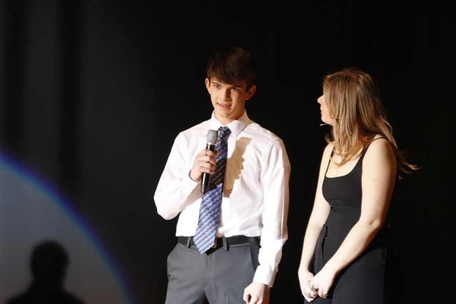 Microphone in hand, Mr. Cross Country junior Lucas Robins answers a question from one of the judges.