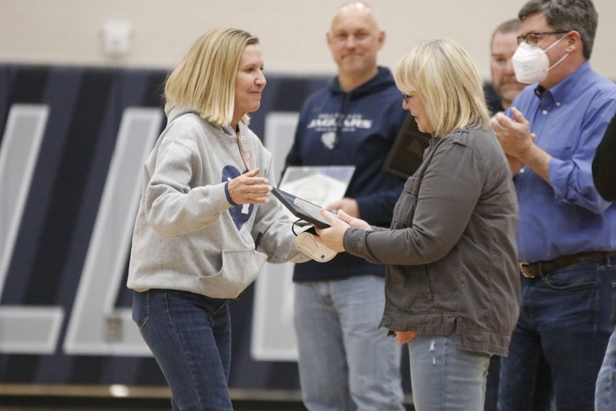 After+receiving+the+award%2C+science+teacher+Betsy+Meeks+looks+down+to+admire+her+plaque.+Meeks+has+worked+at+Mill+Valley+since+2002+and+has+coached+several+sports+including+cross+country%2C+track+and+field%2C+and+basketball.