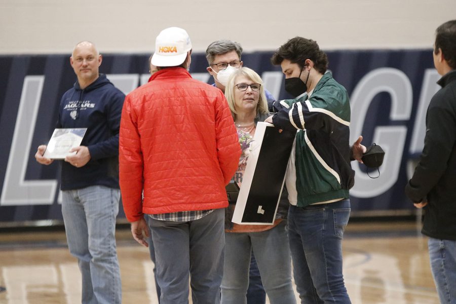 Smiling, science teacher Betsy Meeks thanks her previous student athletes for the gift. 