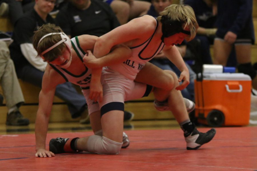 Fighting for a possible title, sophomore Robert Hickman breaks away from his opponent’s grip.