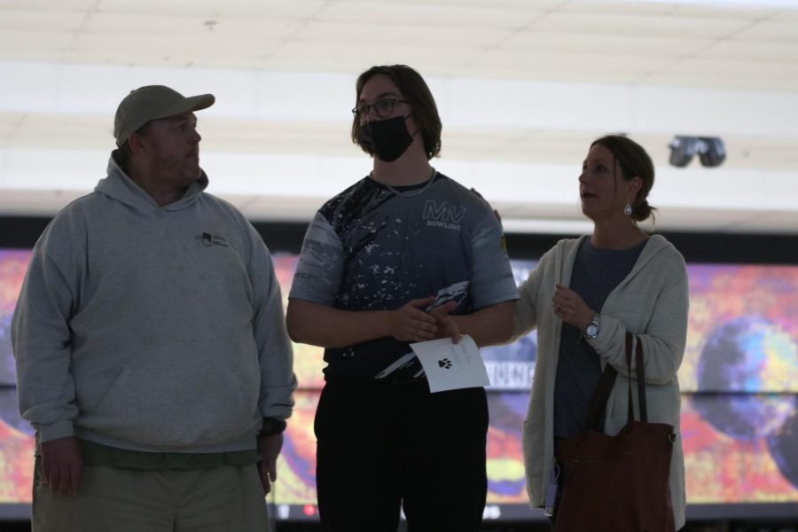 Making eye contact with his friends, senior Laird Toland commemorates his high school bowling career. 
