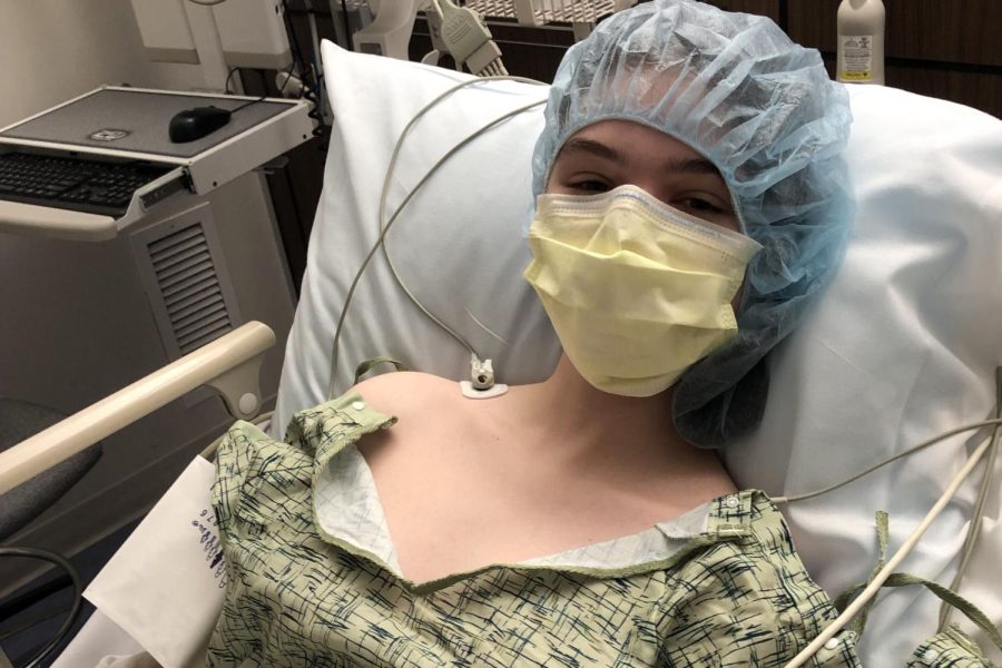 Being prepared for her surgery, senior Taylor Doyle sits in the preoperative room.