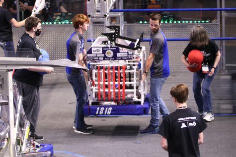 After the round, seniors Darren Hall and Ryan Layton carry the robot out of the ring.