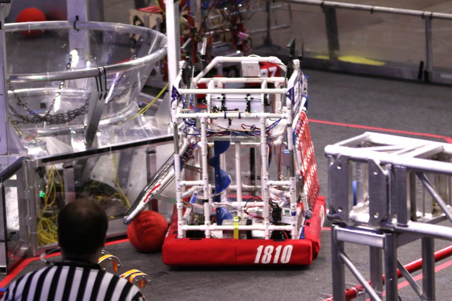 Using the intake, the teams robot collects a red ball for scoring